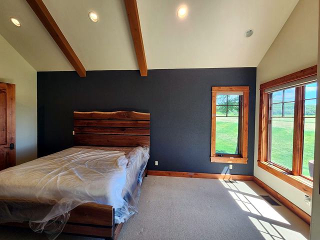 Black accent wall — ranch bedroom: With live-edge headboard