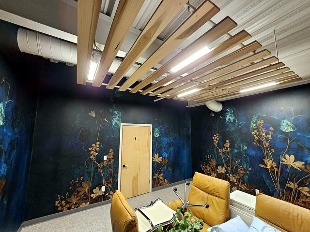 Midnight botanical mural — office: Navy botanical mural with wood-slat ceiling