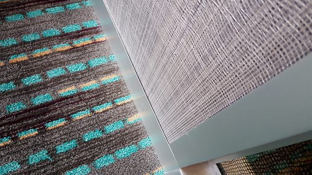 Woven texture — hotel corridor: Weave over patterned carpet