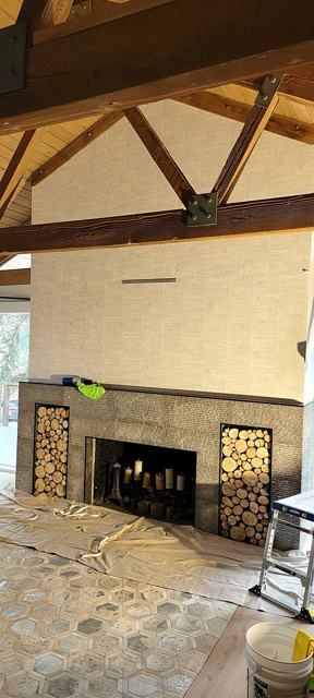 Grasscloth under timber trusses: Fireplace wall